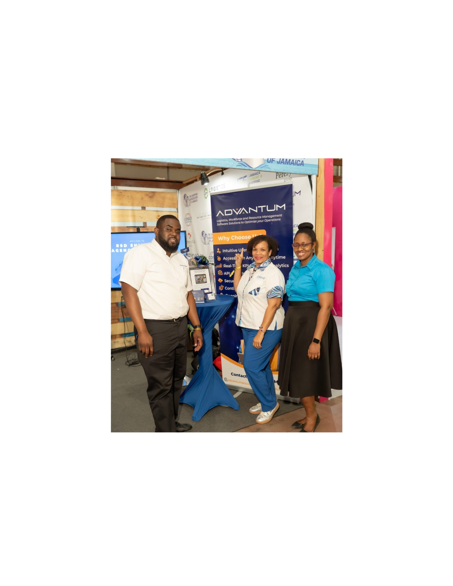 Three attendees at ADVANTUM’s booth at Expo Jamaica 2025.